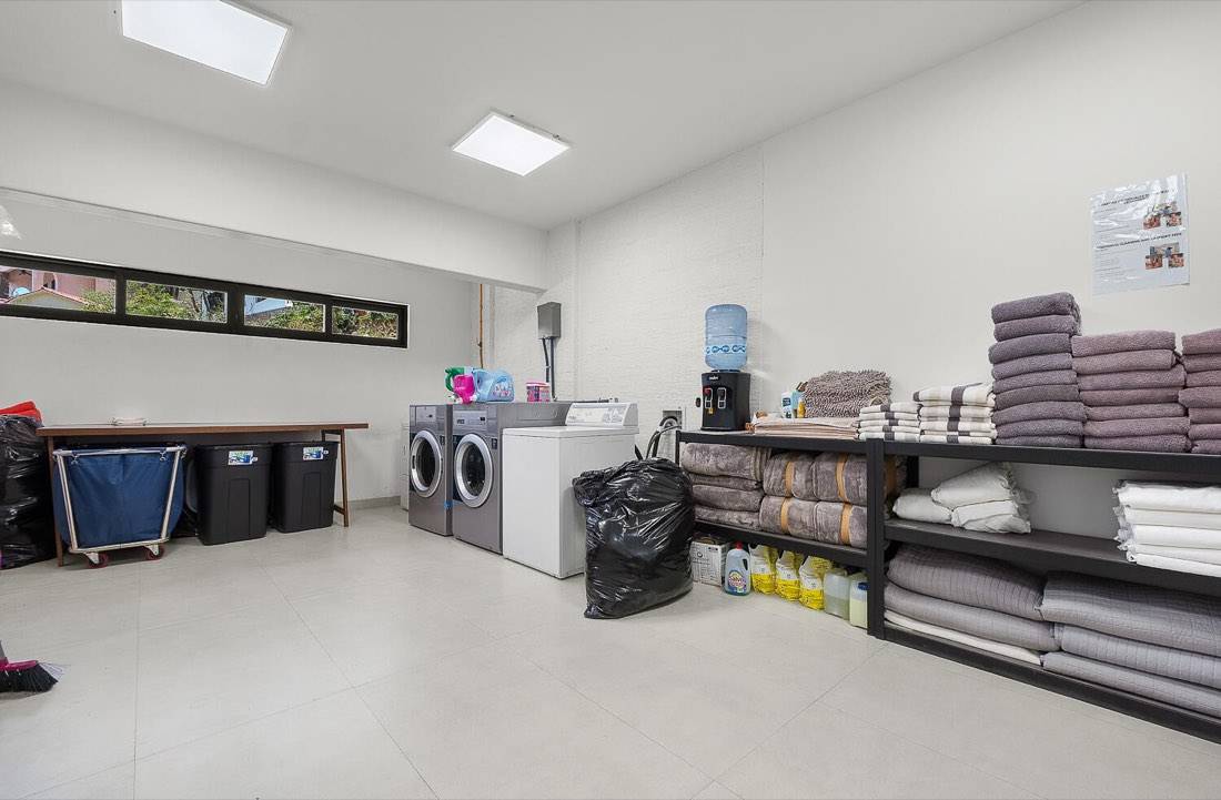 On-site laundry and linen room with commercial washers and dryers