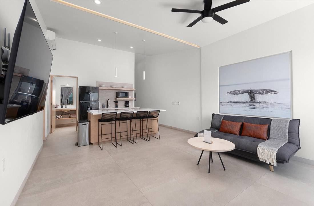 Suite living area with kitchen island, bar seating, and lounge