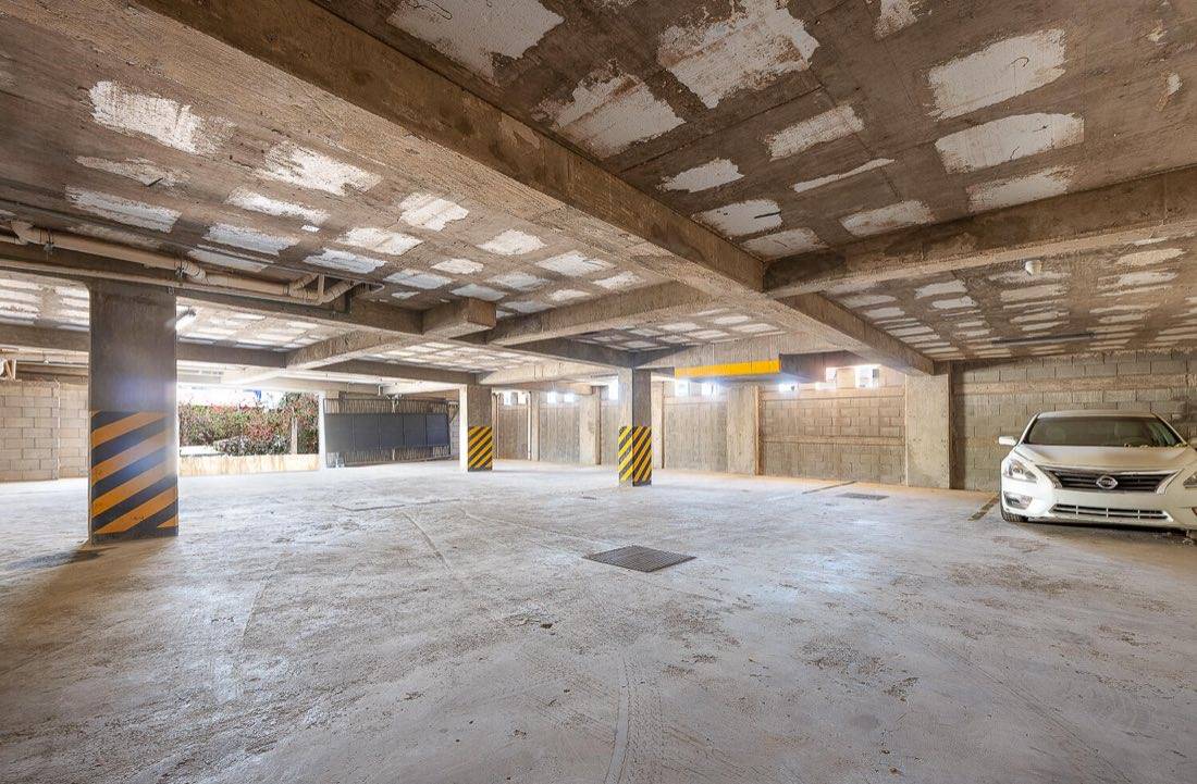 Covered ground-level parking garage with secured entrance