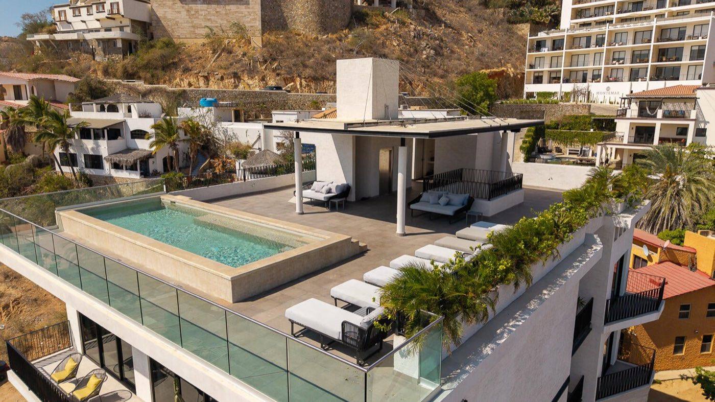 605 Tower rooftop pool deck with cabana and lounge seating overlooking downtown Cabo San Lucas