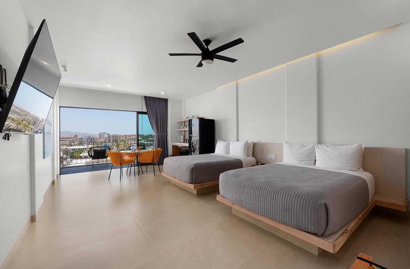 Boutique studio suite with two queen beds, balcony, and downtown Cabo view