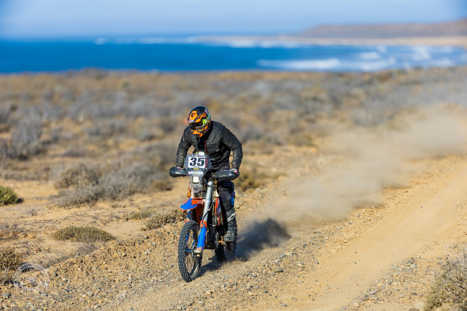 Scott Purcell riding along the Baja coast at golden hour, ocean stretching to the horizon